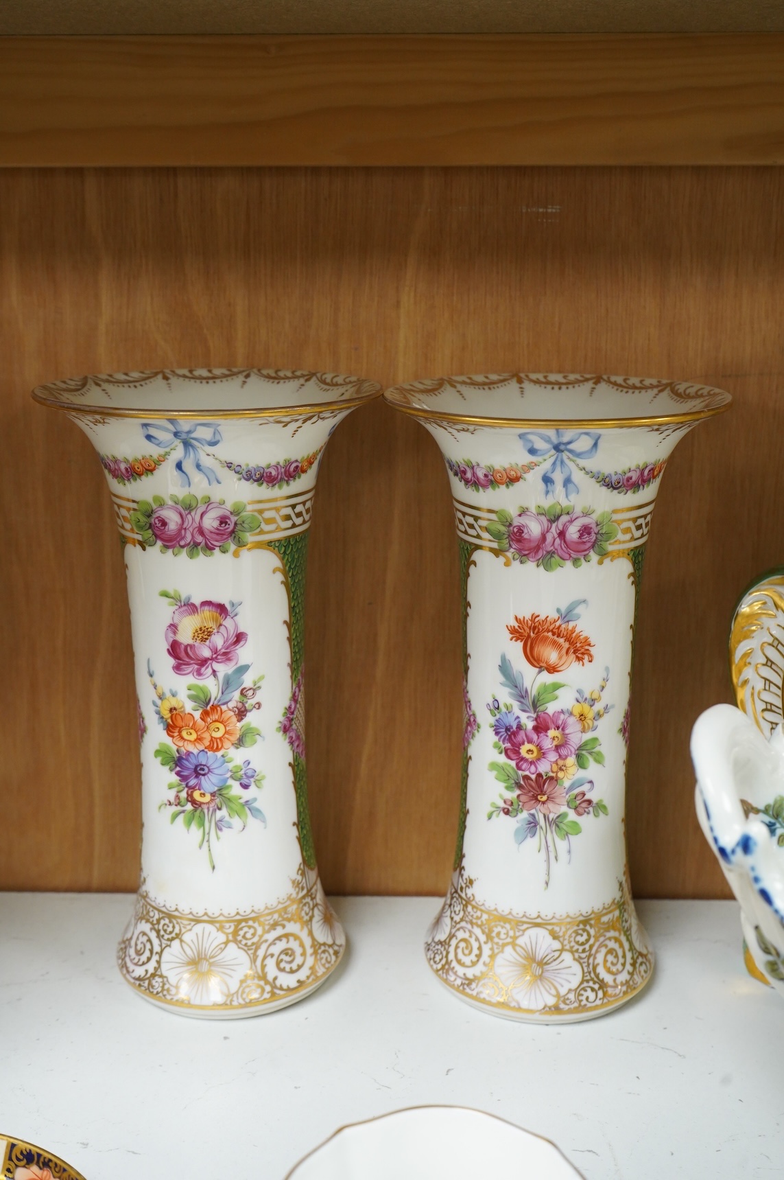A pair of Dresden vases, a Paris porcelain bottle and stopper, a faience bowl and two Royal Crown Derby cups and saucers, tallest 26cm